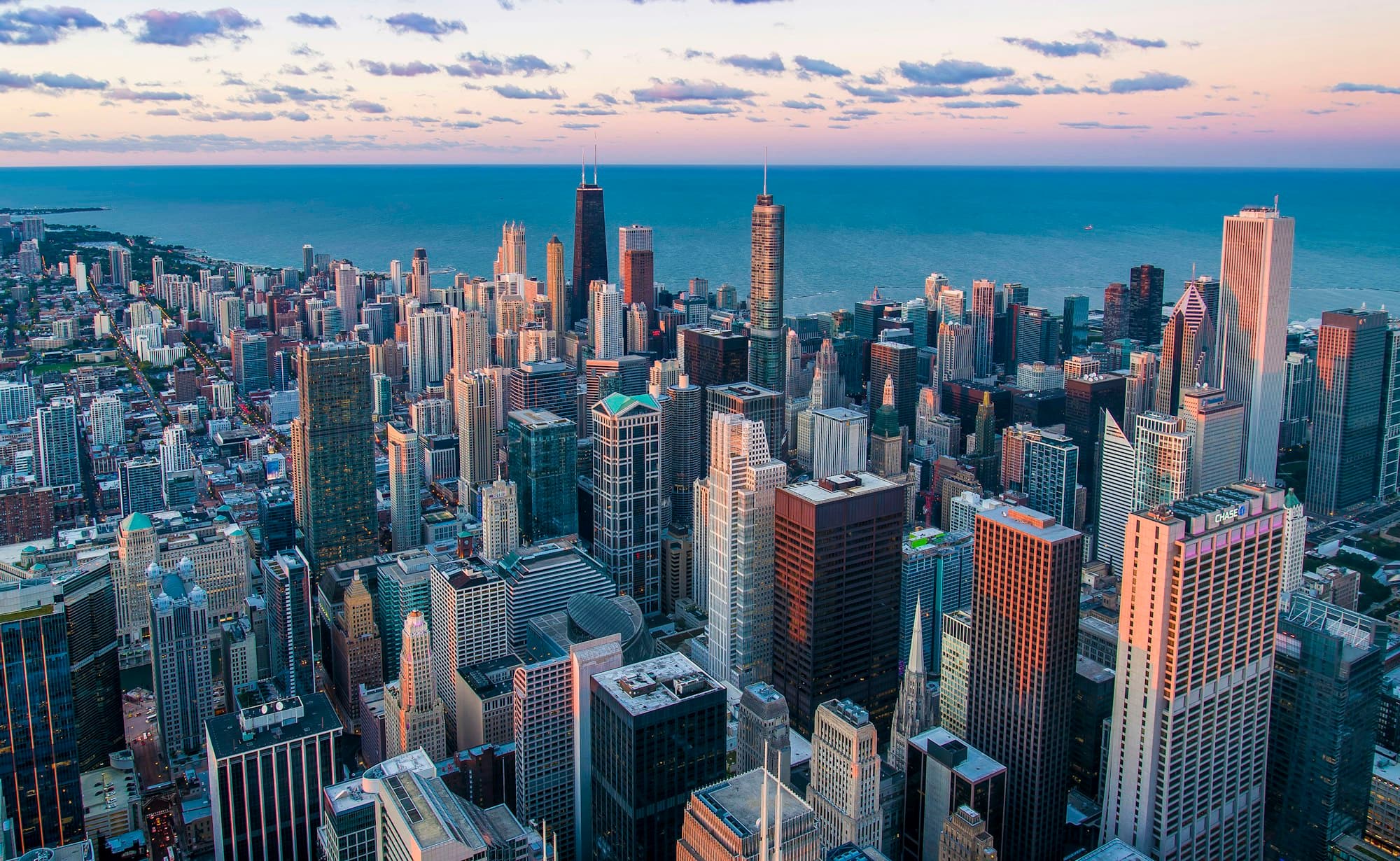 City skyline of glass towers at dusk seen from above