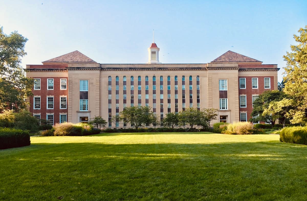 University campus building overlooking a green lawn
