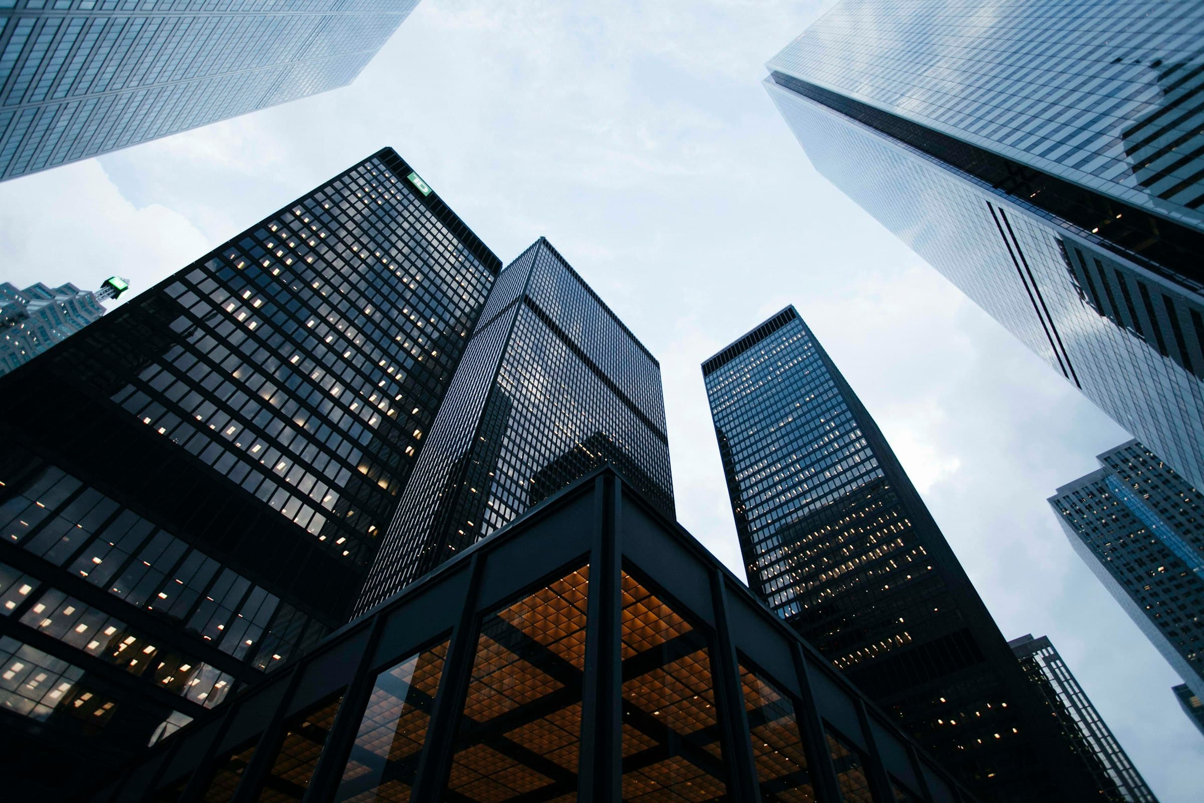 Glass facades of modern corporate towers photographed from below