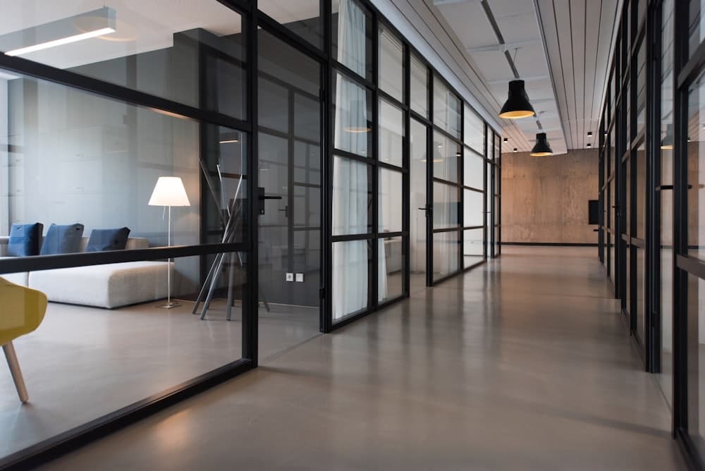 Modern glass-walled corporate office corridor